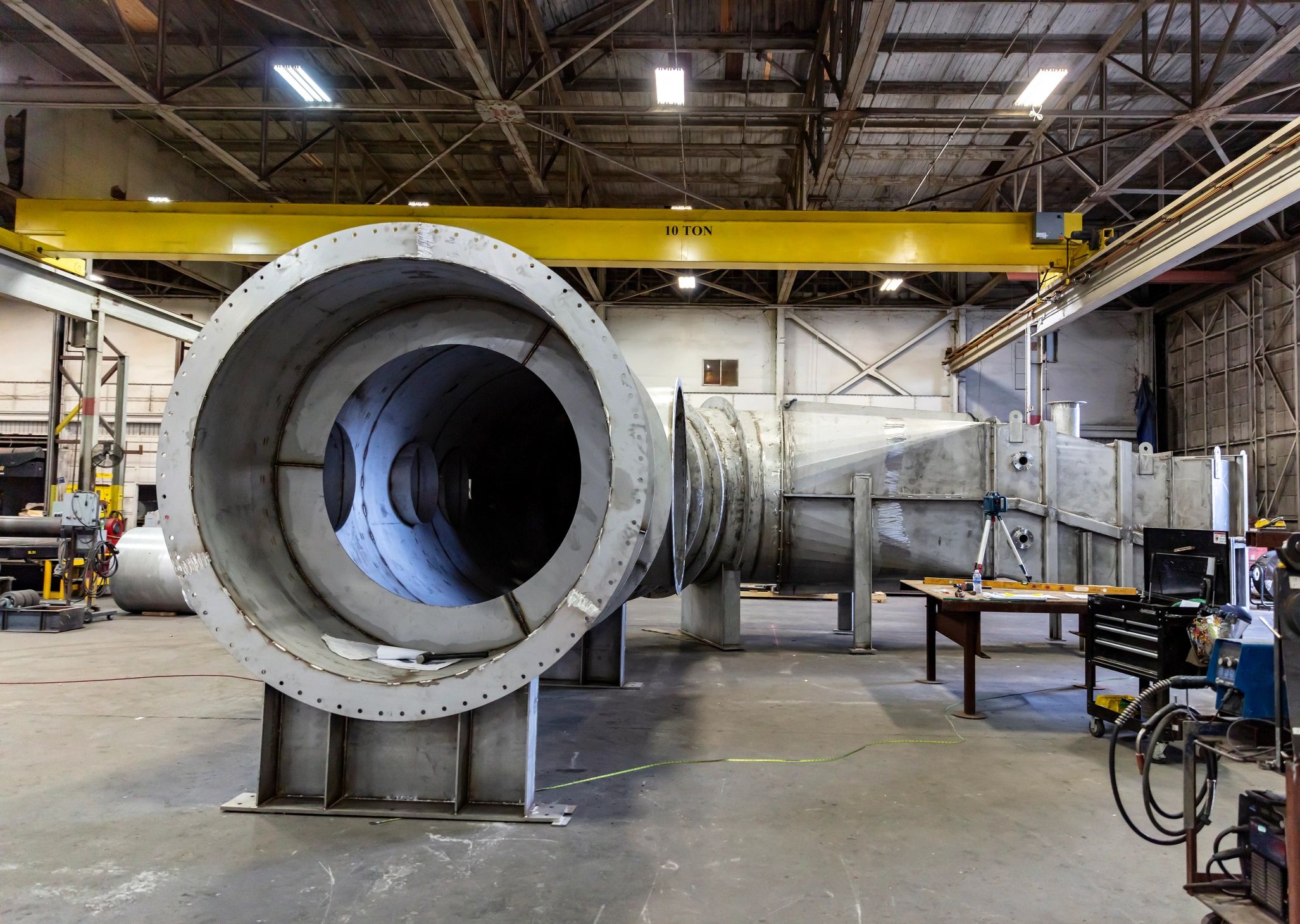 Wide view inside a steel fabrication shop with large fabricated components