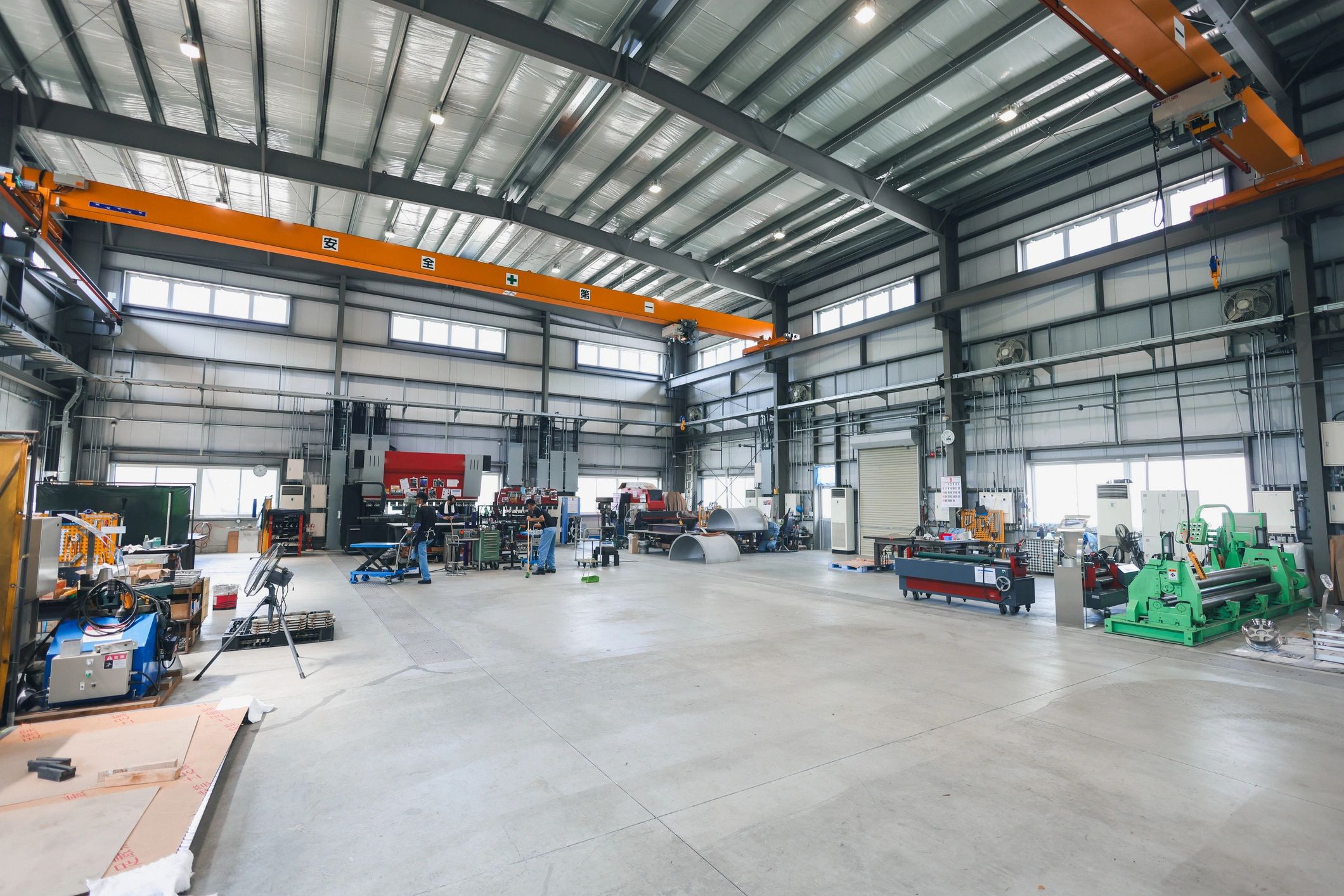 Structural steel fabrication shop interior with beams and equipment