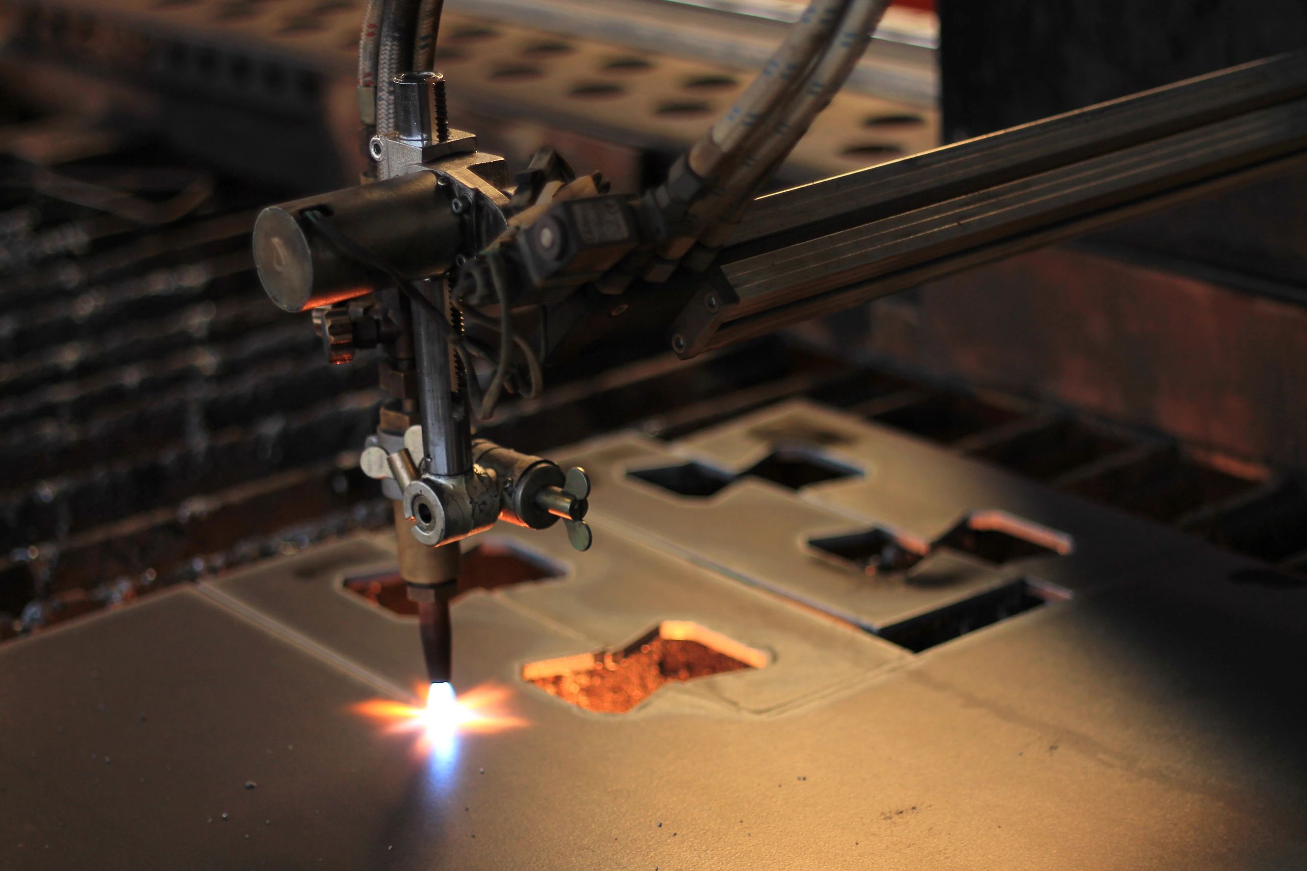Industrial torch cutting metal with sparks