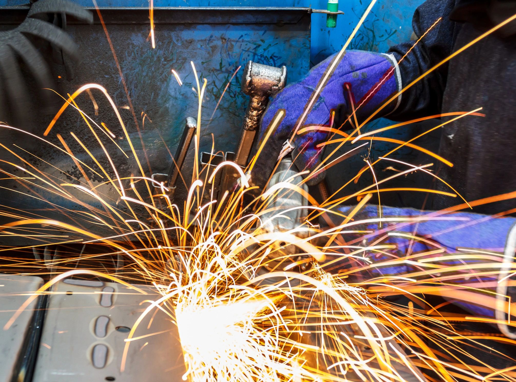 Metal grinding with sparks in a fabrication shop